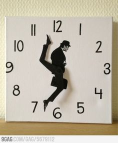 a black and white clock with a silhouette of a man dancing on it's face