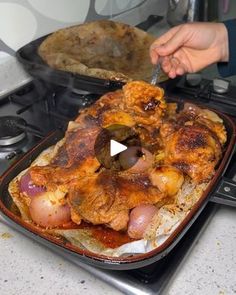 a person cutting up food on top of a stove