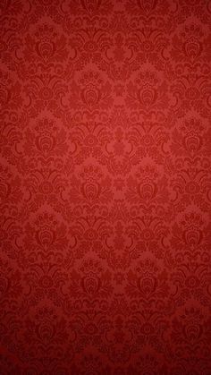 a red wallpaper with an ornate pattern