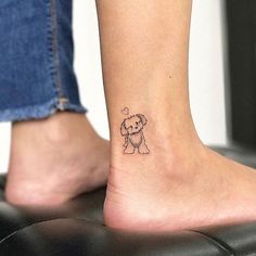 a small dog tattoo on the ankle