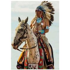 a native american man riding on the back of a brown and white horse with headdress