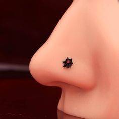 a close up of a nose with a small black star on it's side