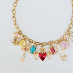 Discover this gorgeous handmade gold charm necklace featuring a variety of cute and lucky charms, perfect for adding a personal touch to any outfit. From delicate flowers to heart pendants, this necklace combines elegance with whimsical details. Whether you're looking for charm necklace ideas or simply love gold jewelry aesthetics, this piece is a stunning addition to any collection. #GoldJewelry #CuteCharms #CharmNecklaceIdeas #LuckyCharms #HandmadeJewelry #goldnecklacedesign Red Heart Necklace, Gold Charm Necklace, Gold Necklace Designs, Cute Charms, Handmade Gold, Delicate Flower, Lucky Charm, Gold Charm, Red Heart