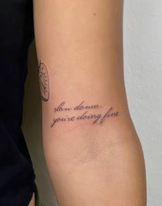 a woman with a tattoo on her arm that says, when you're doing fine