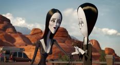 two animated characters standing next to each other in front of mountains and desert area with vehicles