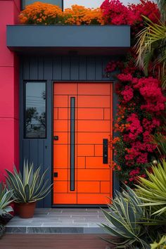 an orange front door surrounded by plants and flowers