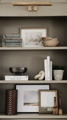 shelves with books, pictures and other items on them