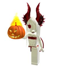 a lego figurine holding a burning pumpkin