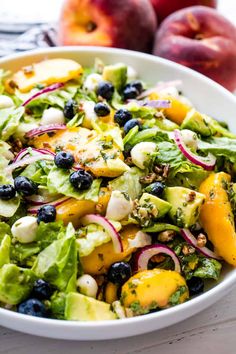 a white bowl filled with salad and fruit