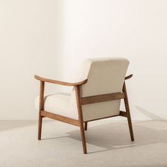 a chair sitting on top of a white floor next to a wall