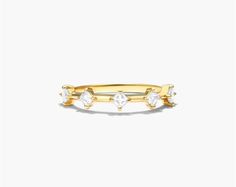 a gold ring with three stones on the front and two small diamonds on the back