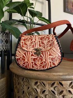 "Beautiful, embossed, genuine leather hand tooled floral purse, skillfully made by Artisans in Mexico using the \"cincelada\" technique. Latch closure and adjustable strap. Includes a storage bag to protect your purse when not in use. Dimensions: 8\" L x 4\" W x 6\" H. (small sized purse). It will fit the standard size phones, and a small wallet, keys and chapstick and or travel sized products, but not an oversized phone (max, plus, etc). Please check measurements if you have any concerns about sizing before purchasing. Imported from Mexico, they are a continuation of the fine craftsmanship established in that country going back hundreds of years with carved leather saddles. These beauties are not like the more common stamped products that can be mass produced cheaply and sold. Each piece Luxury Hand Tooled Shoulder Bag As Gift, Artisan Embossed Shoulder Bag For Daily Use, Hand Tooled Leather Shoulder Bag As Gift, Hand Tooled Leather Shoulder Bag For Gift, Traditional Hand Tooled Shoulder Bag As A Gift, Artisan Shoulder Bag With Leather Lining, Artisan Soft Leather Shoulder Bag, Traditional Bags With Leather Lining As Gift, Traditional Hand Tooled Bags For Everyday Use