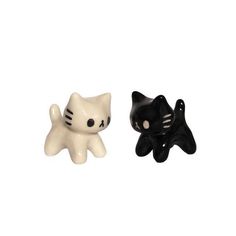 two black and white ceramic cats sitting next to each other