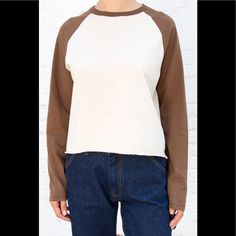 Long Sleeve Baseball Top With Color Blocking And A Raw Hem. Fabrics: 100% Cotton Measurements: 23" (58 Cm) Length, 23" (56 Cm) Bust Made In: Italy Cotton Tops With Contrast Panels For Fall, Fall Cotton Tops With Contrast Panels, White Tops With Contrast Panels For Fall, Beige Cotton Color Block Tops, Beige Color Block Cotton Top, Beige Casual Tops With Contrast Color, Spring Beige Color Block Tops, Brandy Melville Sweatshirt, Tops Brandy Melville