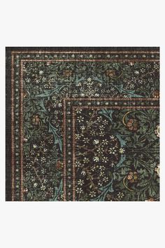 an old rug with floral designs on the bottom, and a green border around it