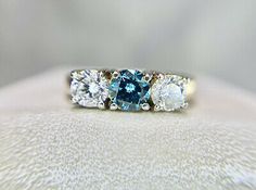 Pinterest Classic Blue Diamond Ring With Brilliant Cut, Blue Round Cut Diamond Ring, Classic Blue Brilliant Cut Diamond Ring, Blue Diamond Ring With Round Cut, Classic Blue Diamond Ring, Classic Blue Diamond Ring With Accents, Blue Three Stone Round Cut Diamond Ring, Blue Diamond Promise Ring With Accents, Blue Three Stone Diamond Ring