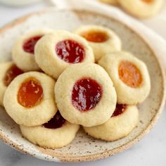 small cookies with jam in the middle on a plate