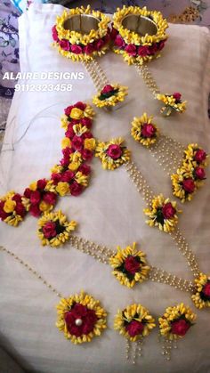 flowers and pearls are laid out on a bed