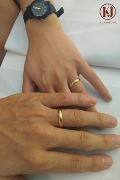 two people with wedding rings on their hands, one holding the other's hand