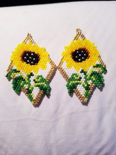 Pretty yellow sunflower in full bloom.  These earrings are two and a half inches long and an inch and a half wide.  Made with glass beads and Wildfire beading thread. Yellow Sunflower Dangle Earrings, Yellow Sunflower Design Dangle Earrings, Bohemian Yellow Sunflower Earrings, Yellow Flower-shaped Beaded Earrings, Yellow Flower Shaped Jewelry With Sunflower Print, Yellow Flower-shaped Jewelry With Sunflower Print, Yellow Beaded Flower Earrings, Yellow Flower Beaded Earrings, Yellow Flower Earrings With Colorful Beads