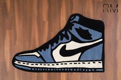 a blue and white nike shoe rug on a wooden floor with the word dm ivvi written below it