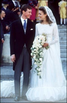 a bride and groom standing next to each other