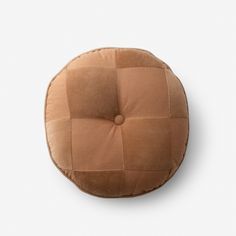 a round cushion made out of brown fabric