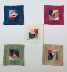 four square pieces of cloth with different colors on them