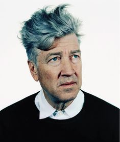 an older man with grey hair and blue eyes