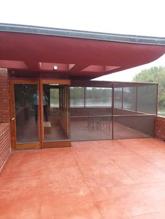 an empty patio with tables and chairs on it