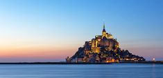 a very tall castle sitting on top of a large body of water