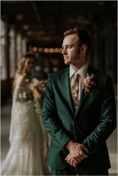 a man in a suit standing next to a woman