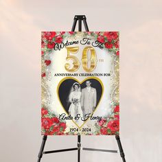 an easel with a 50th wedding anniversary sign on it and red flowers in the background