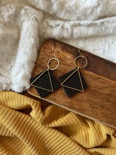 "These leather triangle earrings are 1.5\" in length.  Super lightweight and fun!  This listing is for one pair of Black leather accented with a brass circle and triangle.  They are real leather and come in Gray, Black, Light and Dark Brown.   - Choice of Gold Plated, Gold Fill or Brass Ear Wires - Genuine Leather  - Brass Circle and Triangle These earrings will be ready to ship within 3-5 days. Your little beauties will arrive in a box, ready for gift giving. Please let me know if you would like a little note attached!" Handmade Black Faux Leather Jewelry, Party Leather Dangle Earrings, Trendy Black Earrings For Festivals, Trendy Black Festival Earrings, Adjustable Black Faux Leather Earrings, Leather Dangle Jewelry For Party, Bohemian Adjustable Triangle Earrings, Adjustable Bohemian Triangle Earrings, Bohemian Triangle Adjustable Earrings