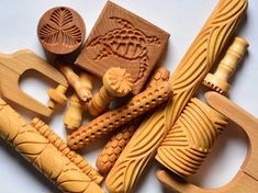 carved wooden toys are displayed on a white surface, including one with a carving tool