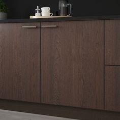 a kitchen with wooden cabinets and black walls