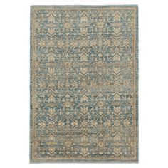 a blue and beige rug with an intricate design on the bottom, in front of a white background