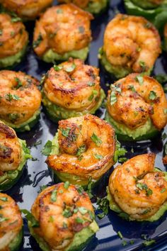 shrimp and avocado cups on a blue platter with garnishes