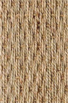 an up close view of the texture of a woven fabric with small braiding on it