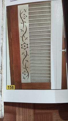 an open window with the blinds closed and some stickers on it's side