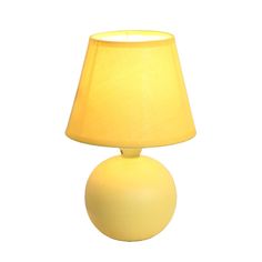 a yellow lamp sitting on top of a table