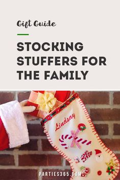 a stocking hanging from the side of a brick wall with text overlay that reads gift guide stockings for the family