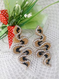 "Earrings in the shape of a snake, embroidered with beads, long earrings of beaded snake jewelry, snake earrings. Earrings are made with beads, strass chain and gimp. 100% handmade. Earrings will emphasize your individuality, originality and uniqueness. It will be a great gift. Earring length 9cm, (3.5 \") Width 4cm, (1.5 \") If you have any questions, please contact me. Thank you for your interest in my work!" Gold Embellished Beaded Earrings For Party, Gold Snake Earrings For Party, Snake Embroidery, Beaded Snake, Earrings Snake, Unusual Gift, Snake Jewelry, Snake Earrings, A Snake