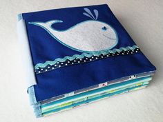 a close up of a cloth book with a whale on it's front cover