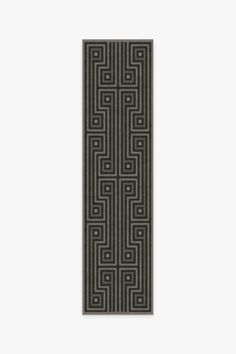 a black and grey rug with an intricate design on the front, along with a white background