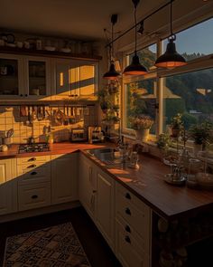 a kitchen with lots of counter space next to a large window that looks out onto the mountains