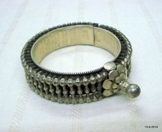 VINTAGE ANTIQUE GREAT DESIGN TRIBAL OLD SILVER HINGE BRACELET BANGLE (KAKAN) FROM RAJASTHAN INDIA. Silver guard bangles (Khatria or bangri gokru) with solid balls perimeters. Worn by DANGEE and PATEL tribal people of Rajasthan. One quarter-hinged part can be opened by central pin. Piece is good worn with a great antique look. See similar samples in” Traditional jewelry of India” by Oppi Untractht.Inner diameter - 4.7 cm(1.85") Outer diameter - 6 cm(2.36")Inner circumference - 14.7 cm(5.8")width Bohemian Oxidized Wedding Bangle, Traditional Metal Bangle For Rituals, Traditional Antique Silver Bangle With Oxidized Finish, Traditional Antique Silver Bangle For Festivals, Silver Temple Jewelry Bracelets For Festival, Bohemian Silver Bangle With Tilla, Vintage Wedding Bracelets For Festive Occasions, Antique Oxidized Bangle For Festivals, Antique Oxidized Finish Bracelet For Festival