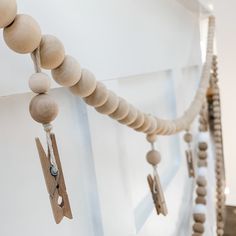 several wooden beads hanging from the side of a wall