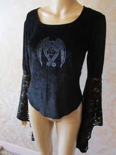 vintage velvet gothic top with a round neck. The sleeves are elbow length with long asymetric lace cuffs.  There is a Gothic Angels motif in silver on the front and it has a slight stretch to it.  This is a gorgeous top in very good condition. Pit to pit;  18" Length;  22" Inside sleeve to wrist;  20" Made by DARK STAR Fitted Gothic Tops, Gothic Long Sleeve Tops For Costume Party, Fitted Fairy Grunge Top, Fitted Fairy Grunge Top For Alternative Fashion, Gothic Tops For Fall Costume, Fairy Grunge Long Sleeve Party Top, Fairy Grunge Long Sleeve Top For Party, Gothic Long Sleeve Top For Costume, Fitted Gothic Top For Halloween