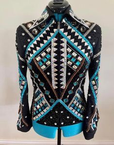 a mannequin wearing a jacket with blue and black designs on it's back